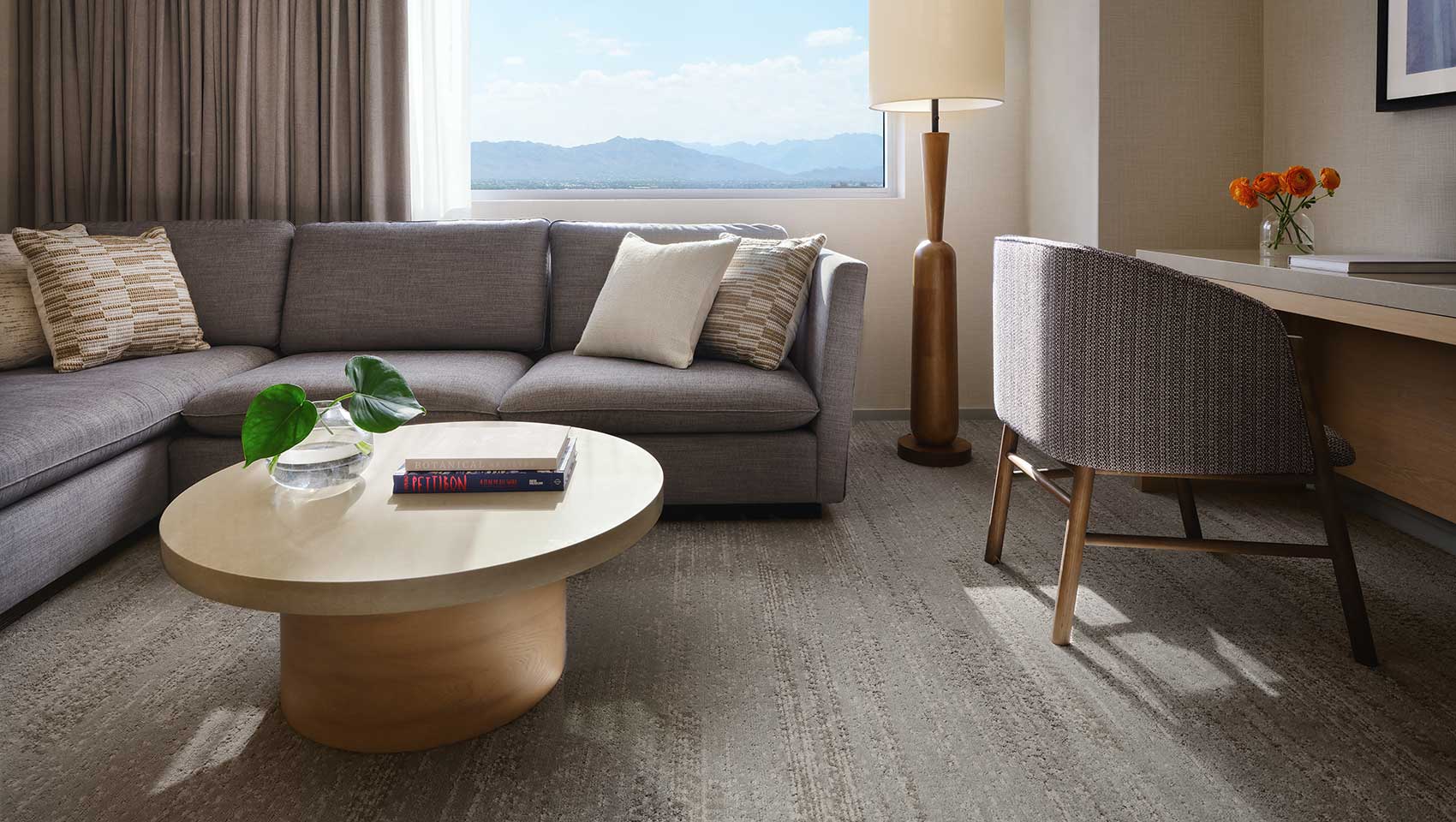 King Suite sitting area with sofa, chair, coffee table, desk, lamp and view of mountains