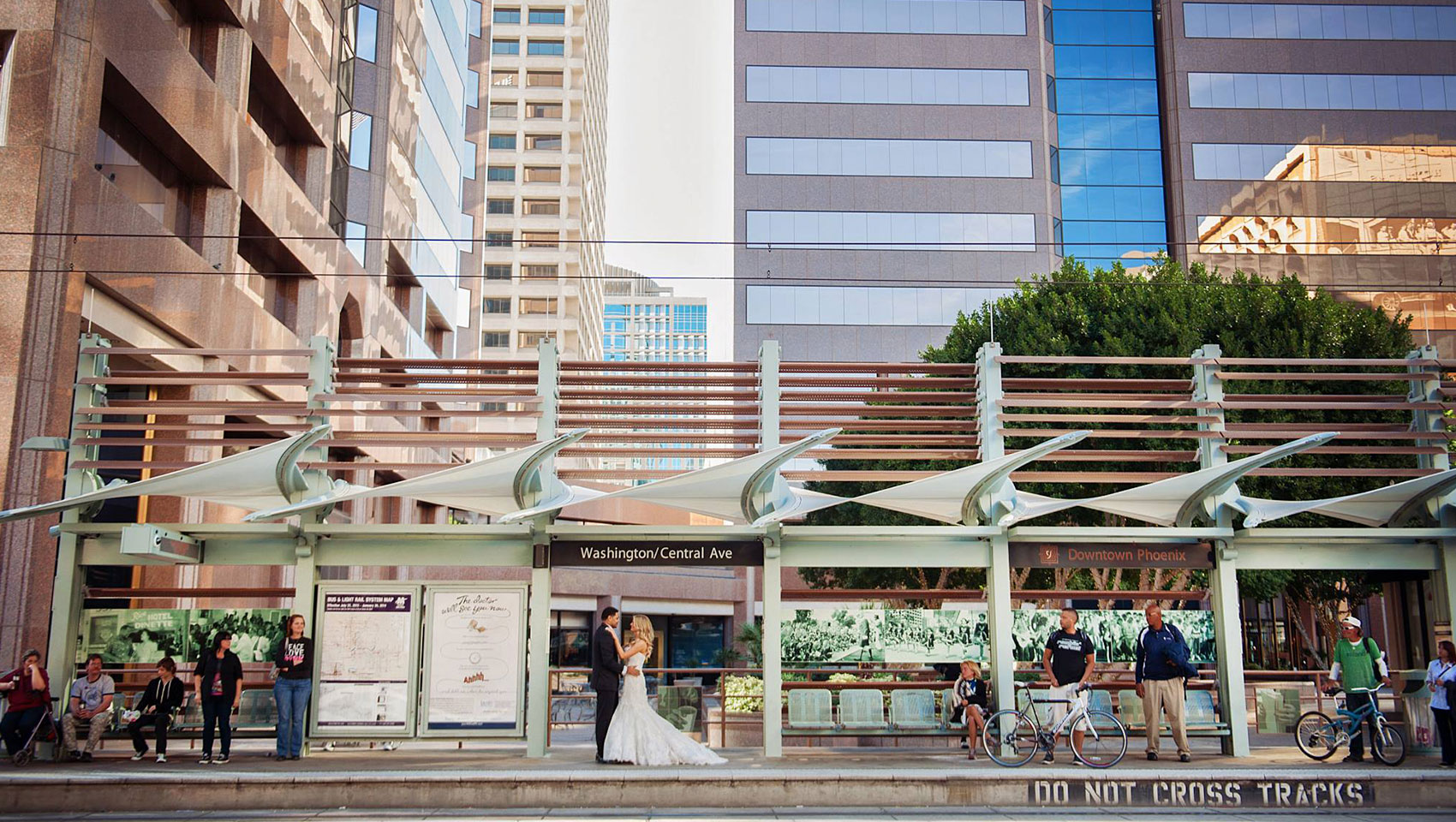 couple standing at the light rail stop