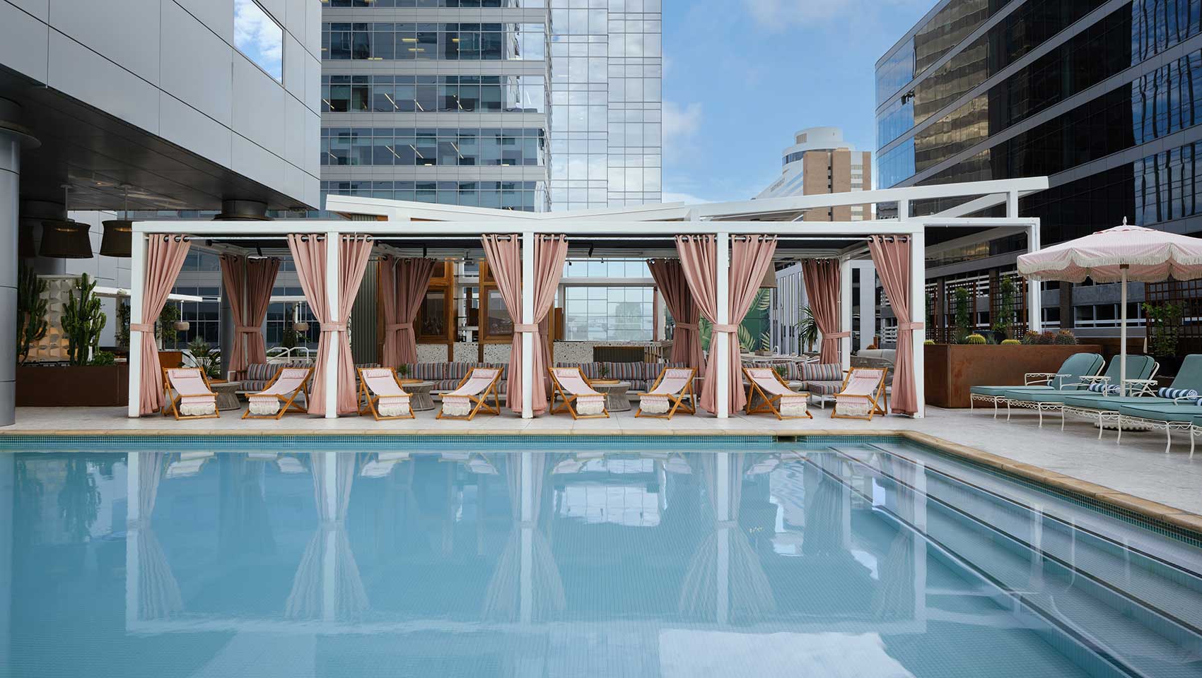 View of Kimpton Hotel Palomar Phoenix rooftop pool with cabanas in the background